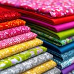 colorful fabrics stacked in a craft store for sale photo